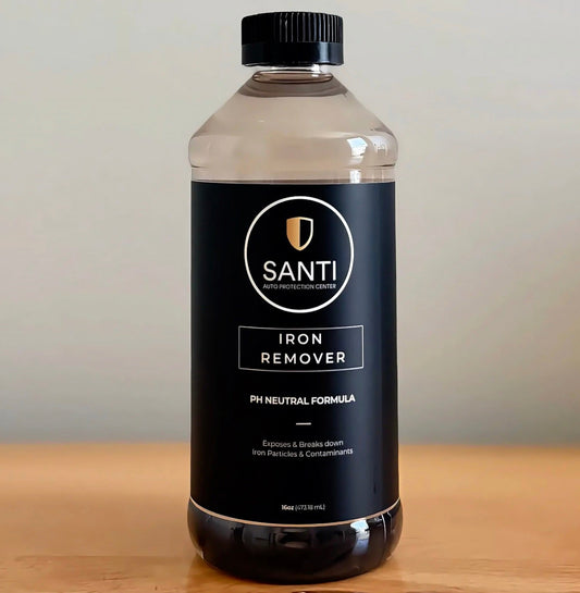 A 5L clear plastic bottle of SANTI Iron Remover pH Neutral Formula with a black cap and black label, sitting on a wooden surface against a neutral beige background.